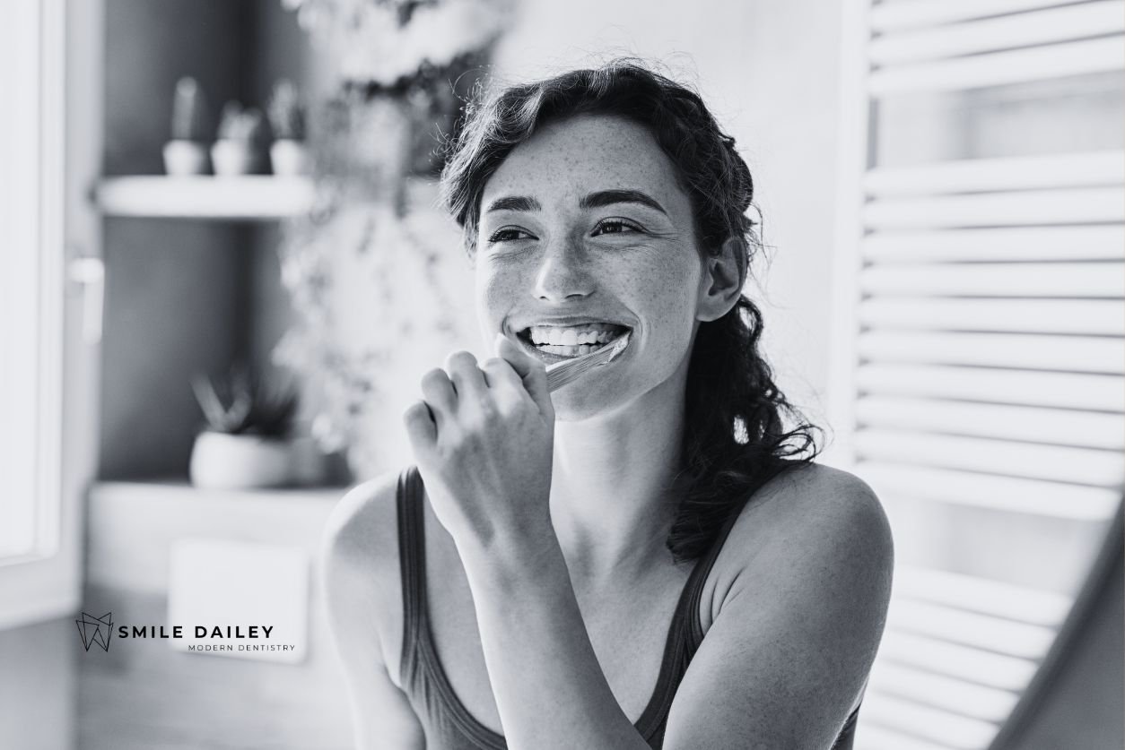 A woman displaying the proper brushing techniques.